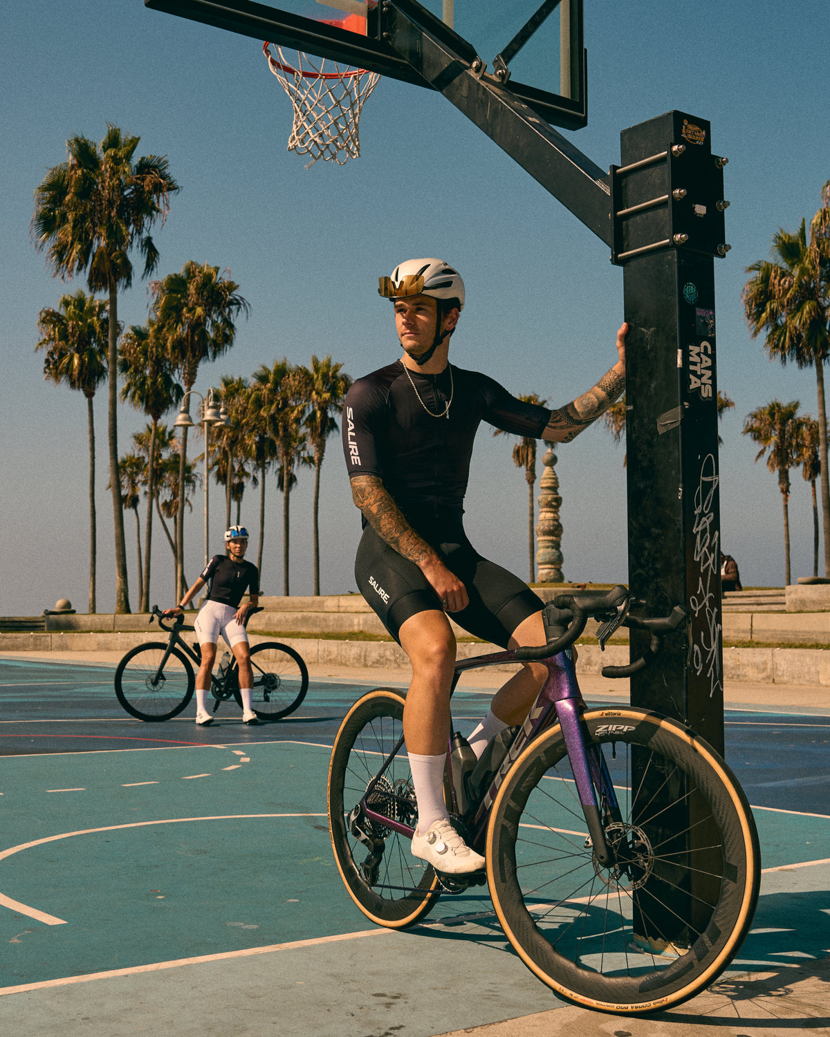 Two cyclist wearing Salire's new kits at a basketball court in Los Angeles 